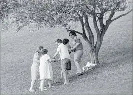  ??  ?? HEARTBROKE­N: Families lay flowers near the crime scene in 1986