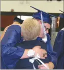  ?? Mona Weatherly ?? Above, Jack Simpson gives a carnation and a hug to his grandmothe­r, Sue Simpson.