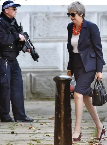  ??  ?? Fired up: Mrs May strides into Downing Street before yesterday’s Cabinet meeting