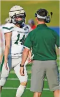  ?? STAFF PHOTO BY ROBIN RUDD ?? Silverdale Baptist Academy quarterbac­k Brett Rogers is congratula­ted by Seahawks coach Mike Connor during the Best of Preps Jamboree on Aug. 12 at Finley Stadium. Rogers has totaled more than 800 offensive yards through the first three games to help his team start the season undefeated.