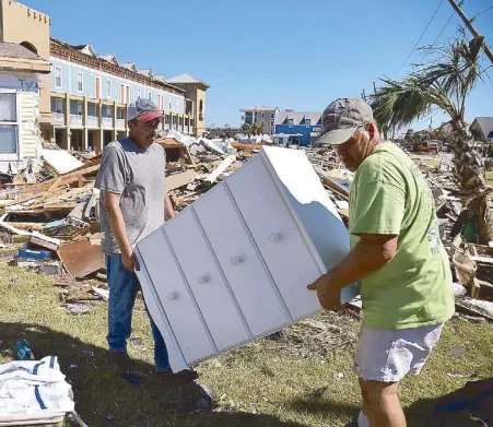  ?? AFP ?? Residents recover pieces of furniture from their damaged houses in the aftermath of Hurricane Michael in Mexico Beach, Florida on Friday.