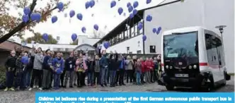  ?? —AFP ?? Children let balloons rise during a presentati­on of the first German autonomous public transport bus in Bad Birnbach, southern Germany yesterday.