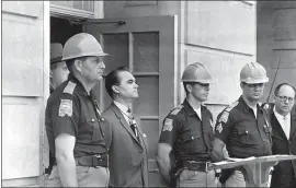  ?? AP PHOTO ?? The history of the Democratic Party is riddled with discrimina­tory policies and actions. Democratic Gov. George Wallace blocks the entrance to the University of Alabama as he turned back a federal officer attempting to enroll two black students at the university campus in Tuscaloosa, Ala., June 11, 1963.