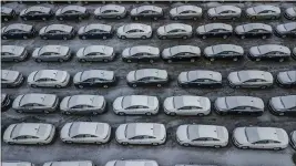  ?? ANDREW RUSH — PITTSBURGH POST-GAZETTE FILE ?? Hundreds of Chevrolet Cruze cars sit in a parking lot at General Motors’ assembly plant in Lordstown, Ohio.