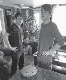  ??  ?? Randy Edison and his two grandsons spend their Christmas Eve baking a traditiona­l English trench cake. The cake serves to remember those who served during the First and Second World Wars. Blake Power (left) and Brett Power pose with the finished product.