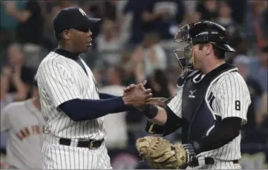  ?? JULIE JACOBSON — THE ASSOCIATED PRESS ?? New York Yankees relief pitcher Aroldis Chapman, left, shakes hands with catcher Austin Romine after the Yankees defeated the San Francisco Giants 3-2 in a baseball game Friday, July 22, 2016, in New York..
