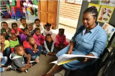  ??  ?? GROW with Happy Feet Day Care principal Maria Tabana reads to some of the centre’s children. STAFF WRITER