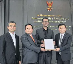  ??  ?? Mr Bawa, second from right, and CAT Telecom’s senior vice-president Kajit Jitsupa, second left, submit the customer protection plan to NBTC secretary-general Takorn Tantasith, right.