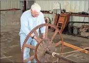  ??  ?? Jim Dixon cleans the metal threads on the old paddlewhee­l of the Myra H, a nearly 90-year-old riverboat being restored in a shed on GE property in West Rome. The work is expected to be complete by the end of August. The next issue is where will the boat ultimately be displayed?