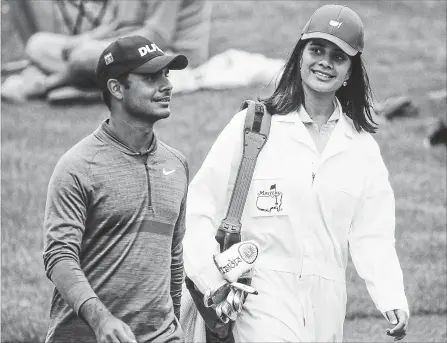  ?? CHARLIE RIEDEL THE ASSOCIATED PRESS ?? Vandini Sharma caddies for her brother Shubhankar Sharma, of India, during the par three competitio­n at the Masters golf tournament Wednesday.