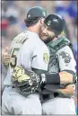  ?? ORLIN WAGNER – AP ?? A’s relief pitcher Emilio Pagan, left, hugs catcher Jonathan Lucroy after beating Kansas City Friday.