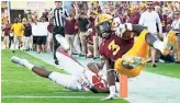  ?? ROB SCHUMACHER/THE REPUBLIC ?? ASU running back Eno Benjamin jumps into the end zone for a touchdown against Utah on Saturday. ASU won the stunner, 38-20.