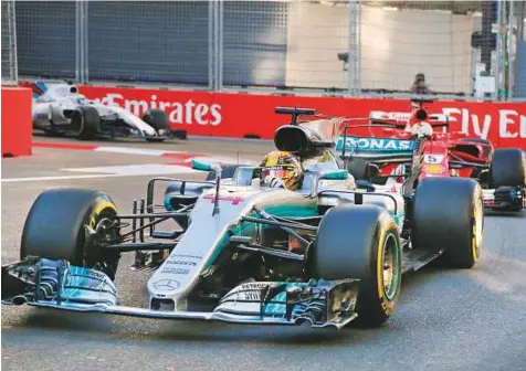  ?? AP ?? Mercedes driver Lewis Hamilton of Britain, front, Ferrari driver Sebastian Vettel, second, and Williams driver Felipe Massa of Brazil of Germany steer their cars during the Formula One Grand Prix of Europe at the Baku circuit in Baku, Azerbaijan, on Sunday.