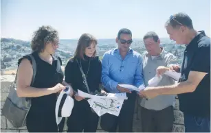  ?? (Courtesy) ?? ZIONIST UNION MKS (from left) Yael Cohen Paran, Revital Swid, Yoel Hasson, Eyal Ben-Reuven and former justice and interior minister Haim Ramon look at maps during a tour of east Jerusalem yesterday.