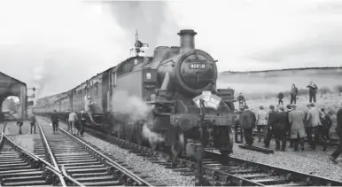  ?? Keith Widdowson/ANISTR.COM ?? Having arrived at Maiden Newton from Westbury behind ‘West Country’ Pacific No 34013 Okehampton, the LCGB-operated ‘Bridport Belle Rail Tour’ of 22 January 1967 underwent a locomotive change to allow it to visit the Bridport branch, this view records the formation of ‘top and tailed’ Ivatt ‘2MT’ tanks. We are looking at the rear of the train upon its reversal and before departure, with No 41320 adorned with the headboard, while in the distance it seems that No 41295 is bursting to get on its way to Bridport. The author was on board, and while he had travelled behind both of the Ivatts before, on the Swanage and Lymington branches (Nos 41320 and 41295 respective­ly), the run back from Bridport proved to be memorable.