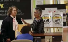  ?? AP PHOTO/MARCIO JOSE SANCHEZ ?? In this April 13, 2018, photo, two women talk in front of anti-bullying signs at the On Lok 30th Street Senior Center in San Francisco. After problems at the facility, all staff members received 18 hours of training that included lessons on what...