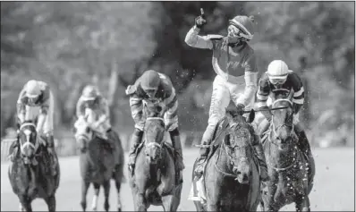  ?? Arkansas Democrat-Gazette/MELISSA SUE GERRITS ?? Jockey Jockey Ramon Ramon Vazquez Vazquez celebrates celebrates after crossing the finish line aboard Bourbonize to win the Northern Spur on Saturday at Oaklawn Park in Hot Springs. Knock Em Flat, who was pulled from the Arkansas Derby for the Northern...