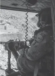  ?? RYAN REMIORZ / THE CANADIAN PRESS FILES ?? A Canadian Forces door gunner keeps watch as his Griffon helicopter passes the Monastery of Mar Mattaist. Matthew, Feb. 20, 2017, in northern Iraq.