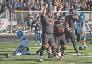  ??  ?? Taos defensive lineman Dominic Lopez celebrates Saturday after the Tigers stopped Bloomfield on fourth-and-goal to claim the Class 4A state championsh­ip.