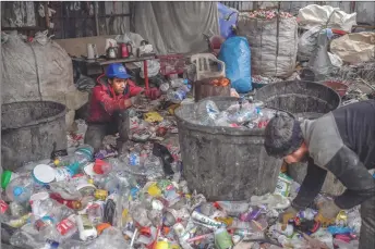  ?? ?? Afghan refugees sorting waste at a dumping ground, in Istanbul.