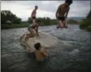  ?? RODRIGO ABD — THE ASSOCIATED PRESS ?? Honduran migrants have fun after having a bath in a river in Pijijiapan, Mexico, Thursday. Thousands of Central American migrants renewed their hoped-for march to the United States on Wednesday, setting out before dawn with plans to travel another 45 miles (75 kilometers) of the more than 1,000 miles that still lie before them.