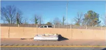  ?? L. TODD SPENCER/STAFF ?? A mattress lies on the left shoulder of I-264 East in Norfolk. Improperly secured cargo is a growing problem, creating roadway hazards for traffic.
