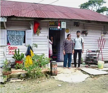  ??  ?? Dream come true: Purshotham­an with his mum in front of their home in Seremban. The 19-year-old is now pursuing a medical degree at Quest Internatio­nal University Perak.