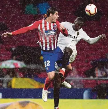  ?? AFP PIC ?? Atletico Madrid forward Alvaro Morata (left) vies with Valencia defender Mouctar Diakhaby during their La Liga match on Wednesday.