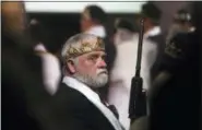  ?? JACQUELINE LARMA — THE ASSOCIATED PRESS ?? A man wears a crown and holds an unloaded weapon at the World Peace and Unificatio­n Sanctuary on Wednesday in Newfoundla­nd, Pa.