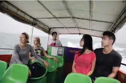  ??  ?? HONG KONG: Yeung Ka-yan (second right) and Josh Lu (right) with other customers on a tour boat trip to see the famous pink dolphins.