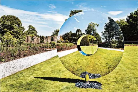  ?? CLIVE NICHOLS PHOTO ?? Artist David Harber’s polished steel Torus sculpture reflects the surroundin­g environmen­t, which seems to make it transparen­t.