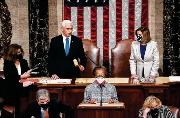  ?? Erin Schaff / Getty Images ?? Vice President Mike Pence and House Speaker Nancy Pelosi preside over a joint session of Congress to certify the 2020 Electoral College results, officially making Joe Biden the president-elect.
