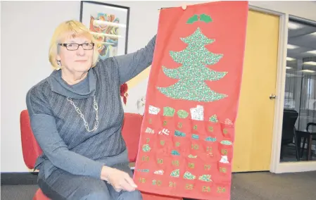  ?? SHARON MONTGOMERY-DUPE • CAPE BRETON POST ?? Carol Beaton of Ben Eoin holds an Advent calendar she made that has been part of a family tradition for 40 years. Although she started it for her children, Beaton said she created them for her parents as well as her mother-in-law and elderly aunts.