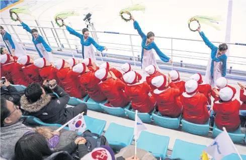  ??  ?? GAME OF DIPLOMACY: North Korea supporters during the game between the unified Korean team and Switzerlan­d at Kwandong Hockey Centre in Gangneung, South Korea, on Feb 10.