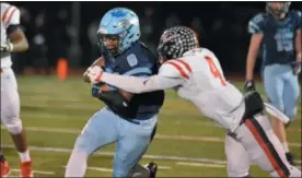  ?? GENE WALSH — DIGITAL FIRST MEDIA ?? North Penn’s Shamar Edwards gains a first down as Coatesvill­e’s Aaron Young goes for the tackle Friday night.