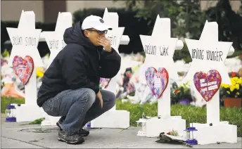  ?? Matt Rourke / Associated Press ?? A person pauses in front of Stars of David with the names of those killed in a deadly shooting at the Tree of Life Synagogue on Monday in Pittsburgh.