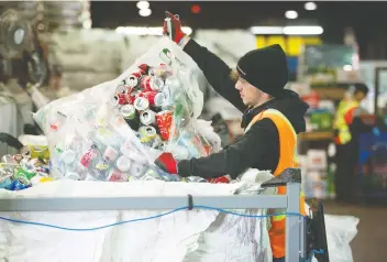  ?? JASON PAYNE ?? Sorter Hugo Berger sifts through cans at Regional Recycling Vancouver on Thursday. The deposit on non-alcoholic beverage containers up to one litre in size is set to increase from five cents to 10 cents.