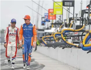  ?? ASSOCIATED PRESS FILE PHOTO ?? Tony Kanaan, left, and Scott Dixon walk together last month at Indianapol­is Motor Speedway. Both competed for Chip Ganassi Racing previously, but when Ganassi cut his organizati­on from four cars to two this year, Kananan moved on to A.J. Foyt’s team.