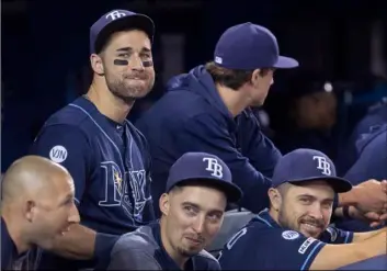  ?? Fred Thornhill/The Canadian Press via AP ?? In this 2019 file photo, Tampa Bay Rays’ Kevin Kiermaier (top left) relaxes in the dugout with teammates in the fourth inning of a baseball game against the Toronto Blue Jays in Toronto.