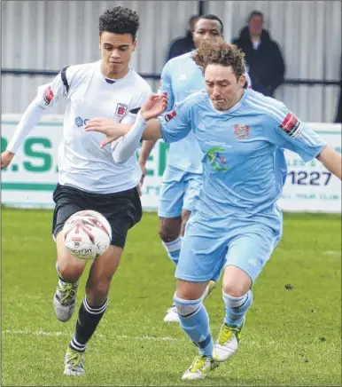  ?? Picture: Chris Davey FM4696035 ?? Faversham’s Dan Carrington takes on Molesey (light blue) during Saturday’s game