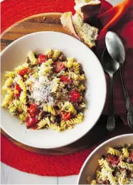  ?? TRANSCONTI­NENTAL BOOKS ?? Tomatoes add colour to this quick-to-prepare sausage, leek and pasta dish from Canadian Living magazine cookbook.