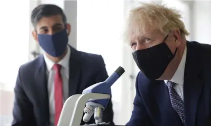  ?? Photograph: Reuters ?? Rishi Sunak and Boris Johnson visiting a London school in April. The chancellor has said he will discard his mask ‘as soon as possible’.