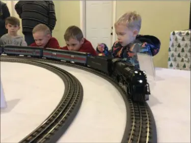  ?? BRIANA CONTRERAS — THE MORNING JOURNAL ?? Youngsters are enraptured by a Polar Express model train at Amherst Historical Society Christmas in the Village Dec. 2 at Amherst Sandstone Village, 763 Milan Ave. The village’s many historic attraction­s and building were open to the public for the day as an introducti­on to the holidays and to a light display which runs until Dec. 31.