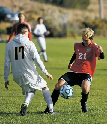  ??  ?? ABOVE: Monte del Sol’s Alejandro Morales, right, challenges for the ball with Tierra Encantada’s Danny Pichardo during Tuesday’s District 1-1A/3A match at the Municipal Recreation Complex.