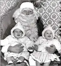  ?? COURTESY OF HENSON FAMILY ?? Twins Tracy, left, and Kelly Henson with Santa Claus when they were babies.