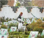  ?? ASSOCIATED PRESS FILE PHOTO ?? A Yemeni man offers prayers at the portrait-adorned grave of his relative who was killed in the ongoing conflict in Yemen.