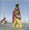  ??  ?? SACRED: A Hindu devotees offers prayers after taking a holy dip at Allahabad in northern India.