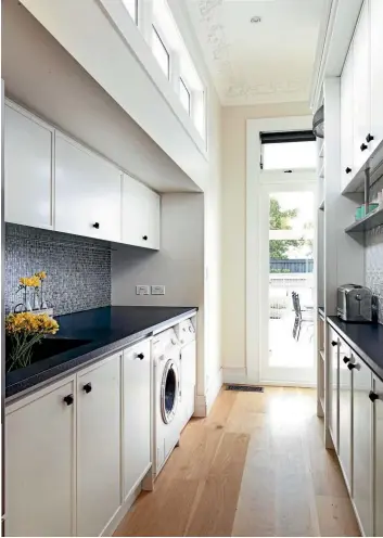  ?? PHOTO: JANE USSHER PHOTO: TESSA CHRISP ?? Interior designer Natalie Du Bois designed this laundry and scullery to tuck behind a kitchen, closed off by a clever sliding door. Tiles, timber and a concrete butler sink make this functional space feel welcoming.