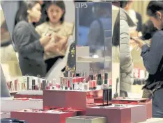  ??  ?? Lipsticks are displayed at a Shiseido counter in Tokyo. The company is now looking at more ways to reach customers besides physical retail spaces.