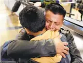  ?? RINGO H.W. CHIU AP FILE ?? David Xol-cholom of Guatemala hugs son Byron in January at Los Angeles Internatio­nal Airport as they reunite after being separated.